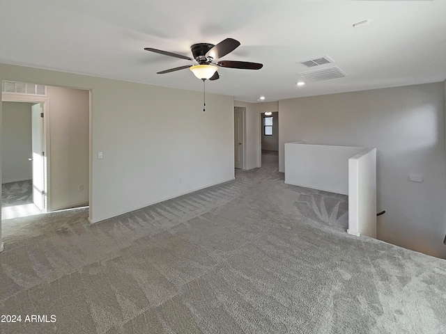 carpeted spare room with ceiling fan