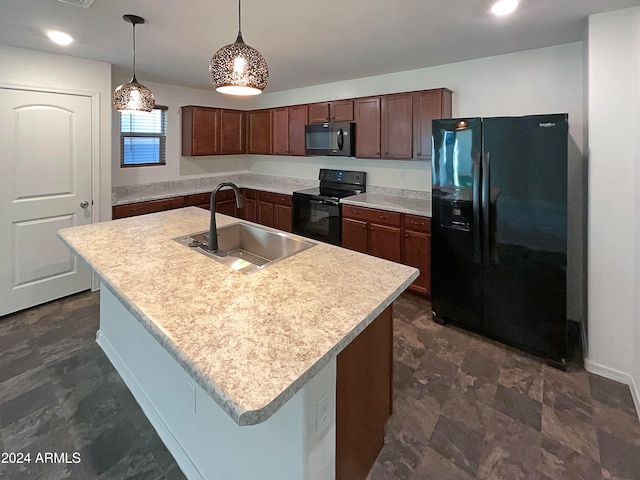 kitchen with a center island with sink, sink, black appliances, and decorative light fixtures