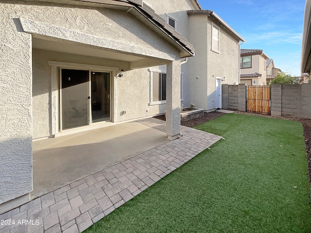 rear view of property with a patio area and a lawn