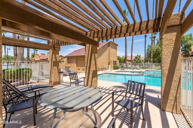 view of swimming pool featuring a patio area and a pergola