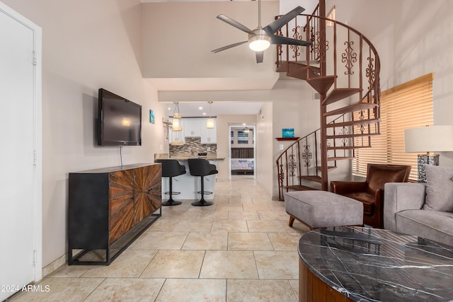 tiled living room featuring ceiling fan