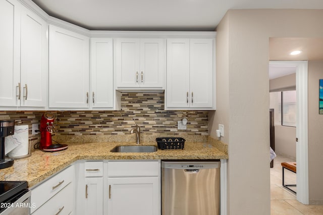 kitchen featuring tasteful backsplash, sink, stainless steel appliances, white cabinets, and light stone counters