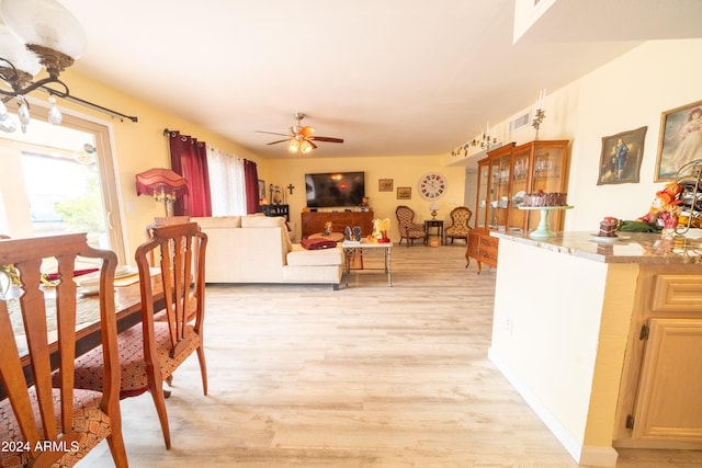 dining room with ceiling fan and light hardwood / wood-style floors