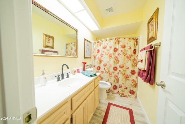 bathroom featuring hardwood / wood-style floors, vanity, and toilet