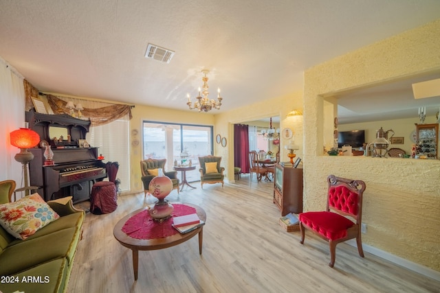 living room with hardwood / wood-style flooring and an inviting chandelier