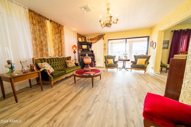 living room with a chandelier and light hardwood / wood-style floors