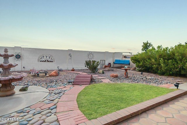 yard at dusk with outdoor lounge area