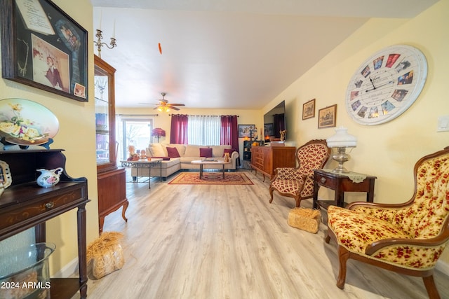 living room with light hardwood / wood-style floors and ceiling fan