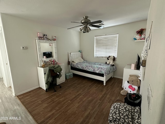 bedroom with ceiling fan and dark wood-type flooring