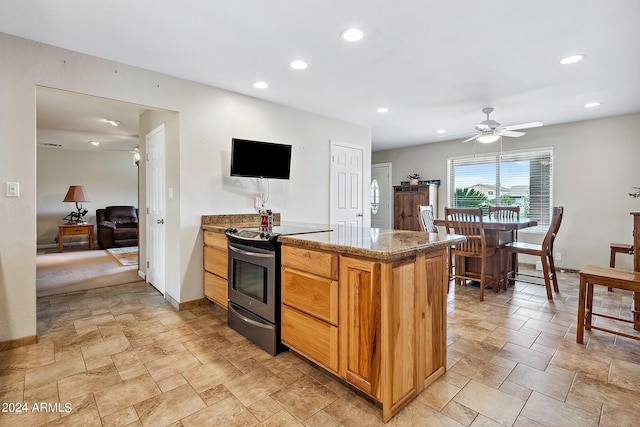 kitchen with stainless steel electric range oven and ceiling fan