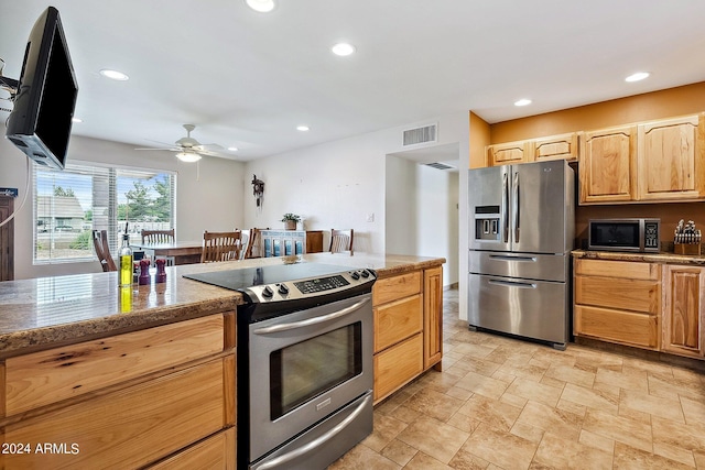 kitchen with light brown cabinetry, ceiling fan, and appliances with stainless steel finishes