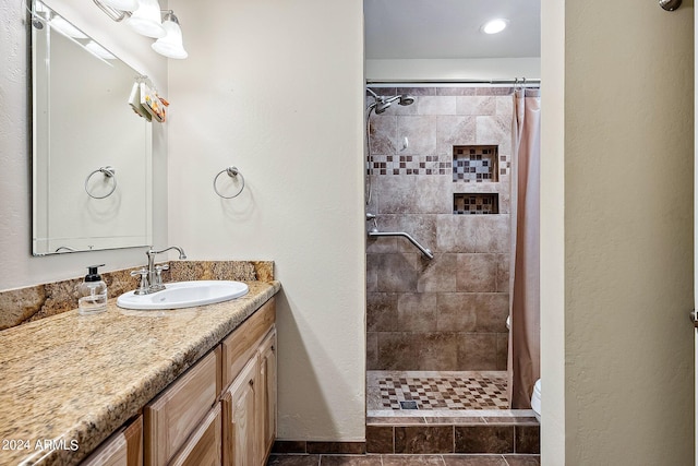 bathroom with vanity, toilet, and curtained shower