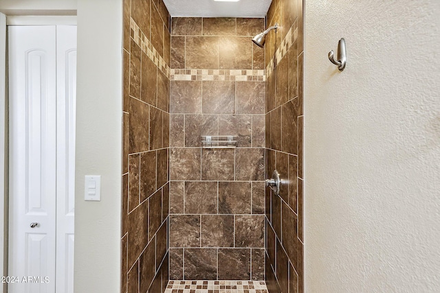 bathroom with tiled shower