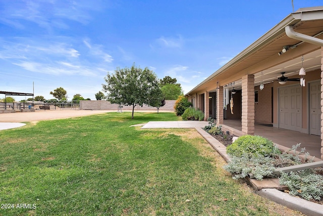 view of yard featuring ceiling fan and a patio area