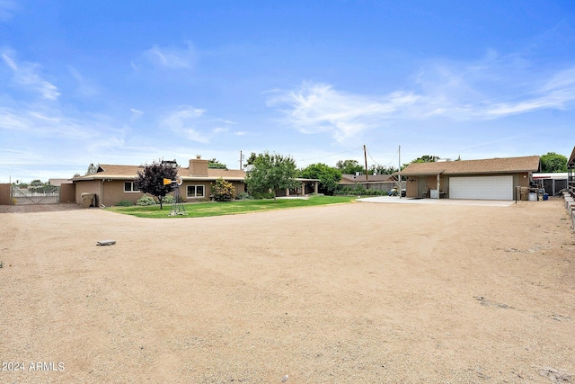 ranch-style home featuring a garage and a front yard