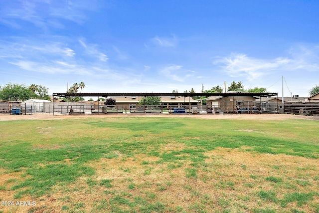 view of yard featuring a rural view and an outdoor structure