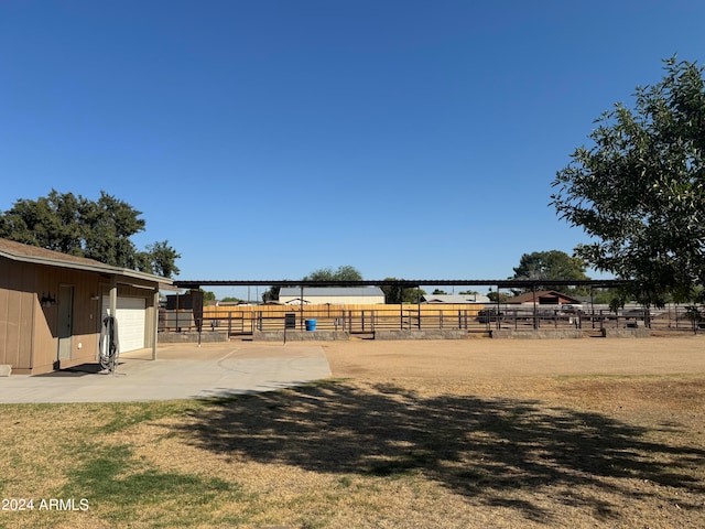 view of yard featuring an outbuilding and a rural view