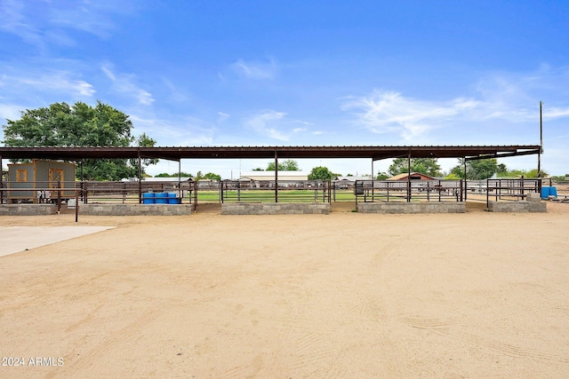 view of community with a rural view and an outdoor structure