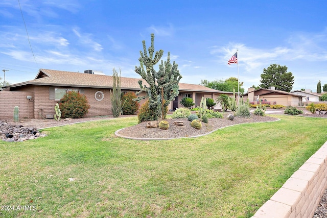 ranch-style house featuring a garage and a front yard