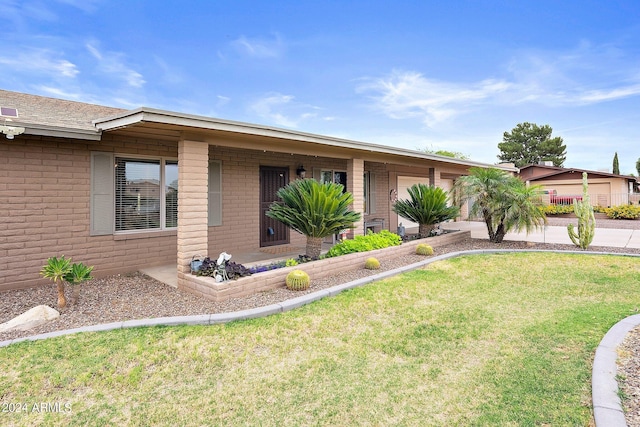 ranch-style house with a front lawn