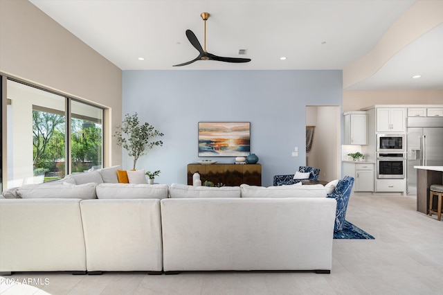 living room with ceiling fan and light tile patterned floors