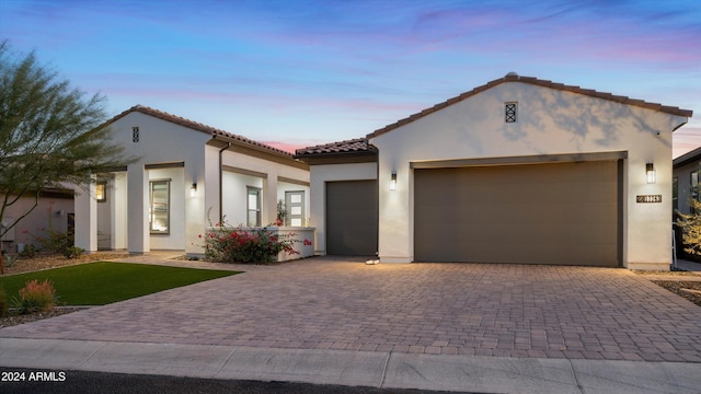 mediterranean / spanish-style house with a garage