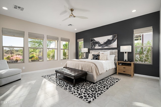 bedroom with ceiling fan and multiple windows