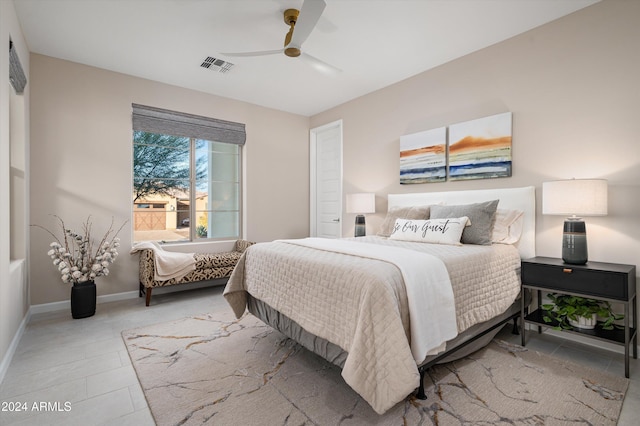 tiled bedroom featuring ceiling fan