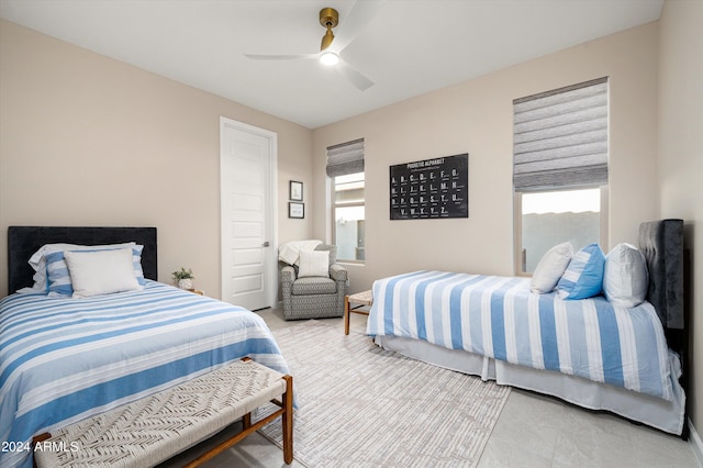 bedroom featuring ceiling fan and multiple windows