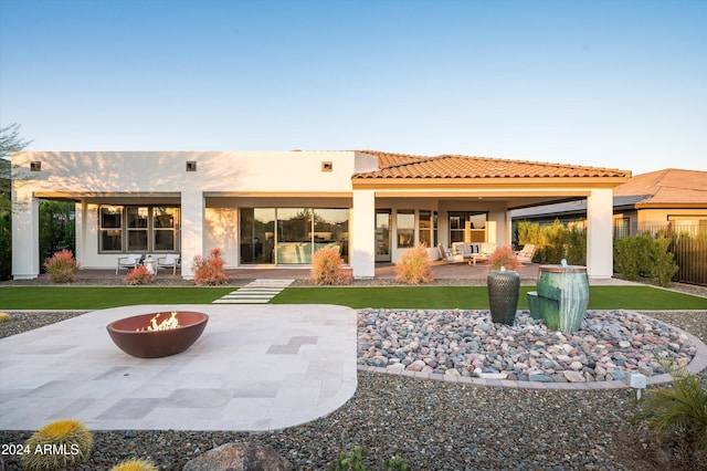 back of house with a patio and a fire pit