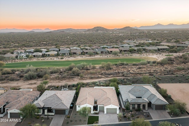 aerial view at dusk featuring a mountain view