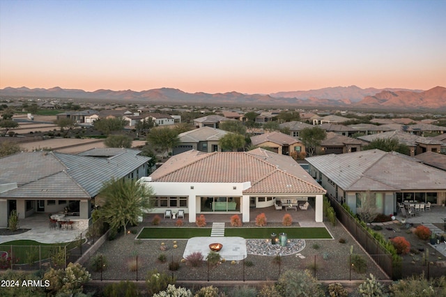 aerial view at dusk featuring a mountain view