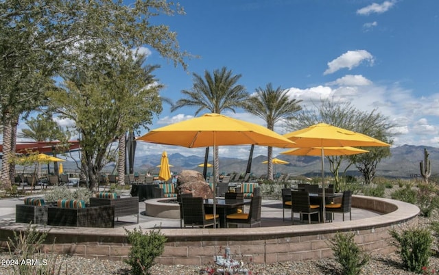 view of property's community with a fire pit and a mountain view