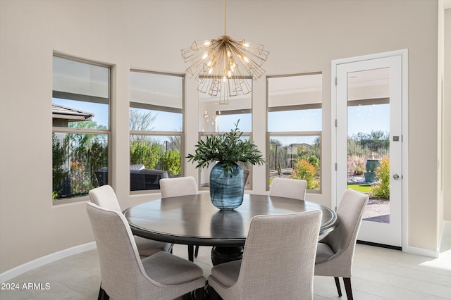 tiled dining area featuring a chandelier