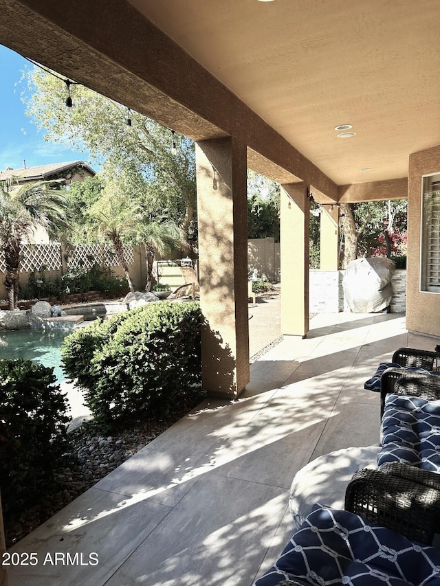 view of patio featuring fence