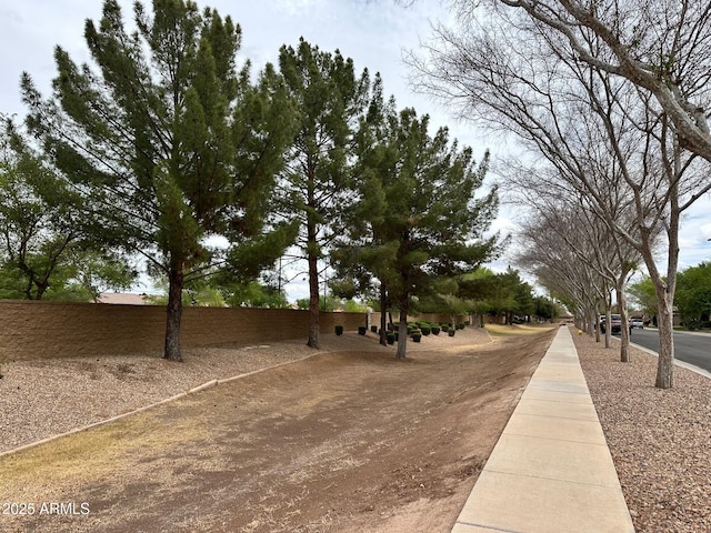 view of property's community featuring fence