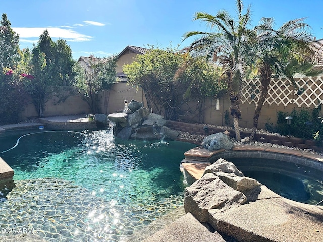 view of pool with an in ground hot tub, a fenced backyard, and a fenced in pool