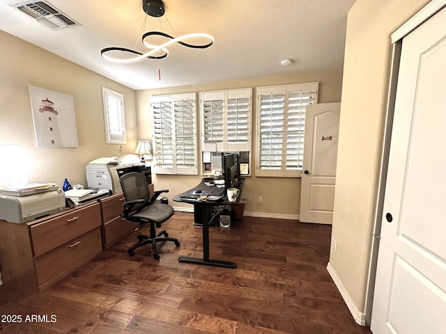 home office with wood finished floors, visible vents, a chandelier, and baseboards