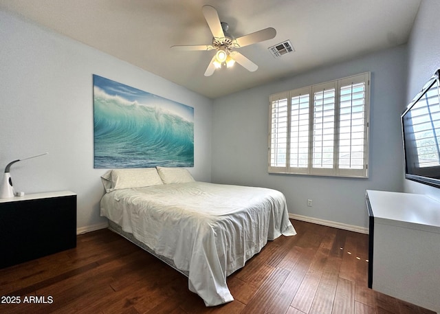 bedroom featuring visible vents, baseboards, wood finished floors, and a ceiling fan