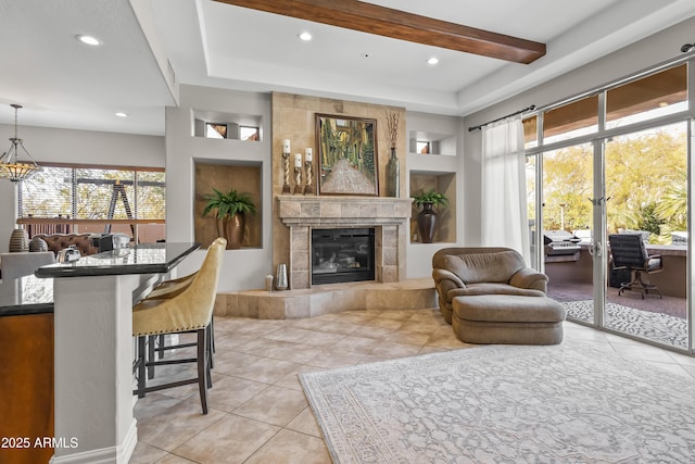 living area with built in features, recessed lighting, light tile patterned floors, and a tile fireplace