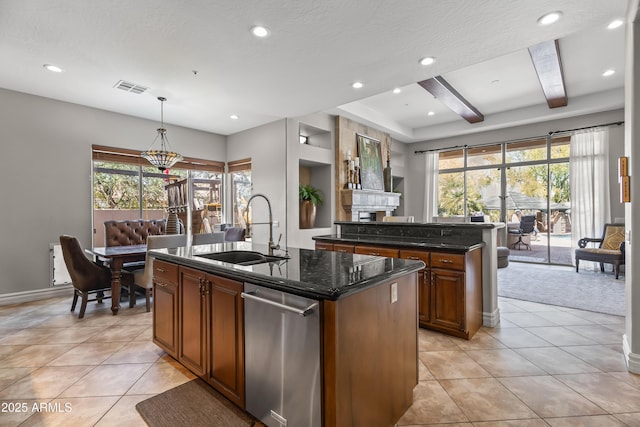 kitchen featuring visible vents, beam ceiling, an island with sink, a sink, and light tile patterned flooring