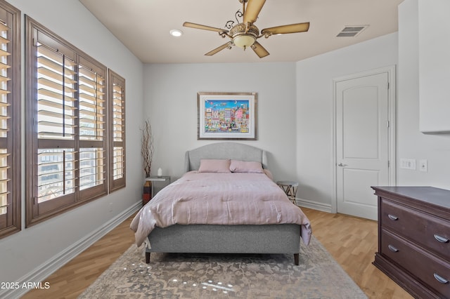 bedroom featuring a ceiling fan, light wood-style flooring, baseboards, and visible vents