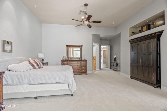 bedroom with ceiling fan, light colored carpet, visible vents, and baseboards