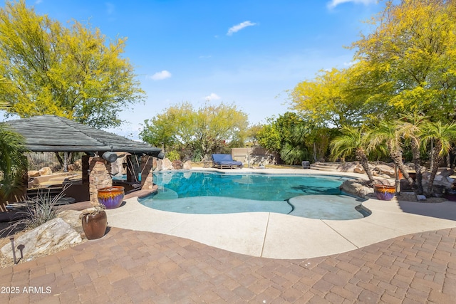 view of swimming pool with a fenced in pool, fence, and a patio area