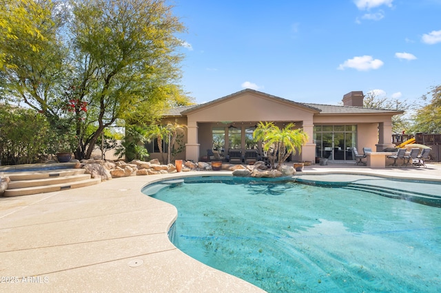 outdoor pool with a patio and fence