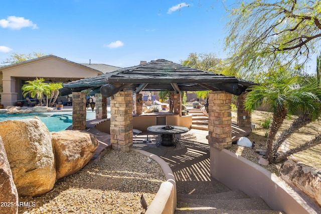 view of patio / terrace with an outdoor pool and a gazebo