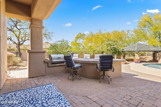 view of patio with a fenced in pool, fence, outdoor wet bar, area for grilling, and grilling area