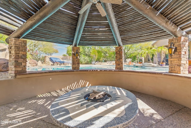 view of patio / terrace with an outdoor pool and a fire pit