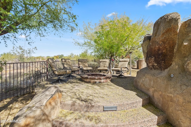 view of yard featuring a patio area, a fire pit, and fence