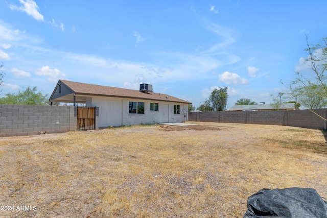 207 E Thomas St, Casa Grande, AZ 85122 - rear view of property featuring a fenced backyard and central AC